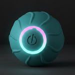 Teal ball with glowing pink ring on a dark background, featuring sound level information.